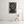 Poster with 'ERROR 404' design on a wall in a room with a chair and lamp.