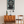 Room interior with wooden cabinet, chair, lamp, and 'ERROR 404' poster on the wall.