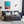 Modern bedroom with geometric bedding, colorful wall art, and decorative items.
