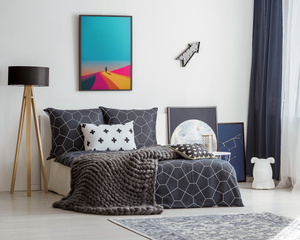Modern bedroom with geometric bedding, colorful wall art, and decorative items.
