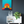 Framed artwork of a sunset with a person on a path above a white cabinet with decorative items.