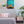 Bedroom with a colorful sunset painting above the bed