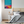 Bedroom with a colorful abstract painting on the wall above a bed.